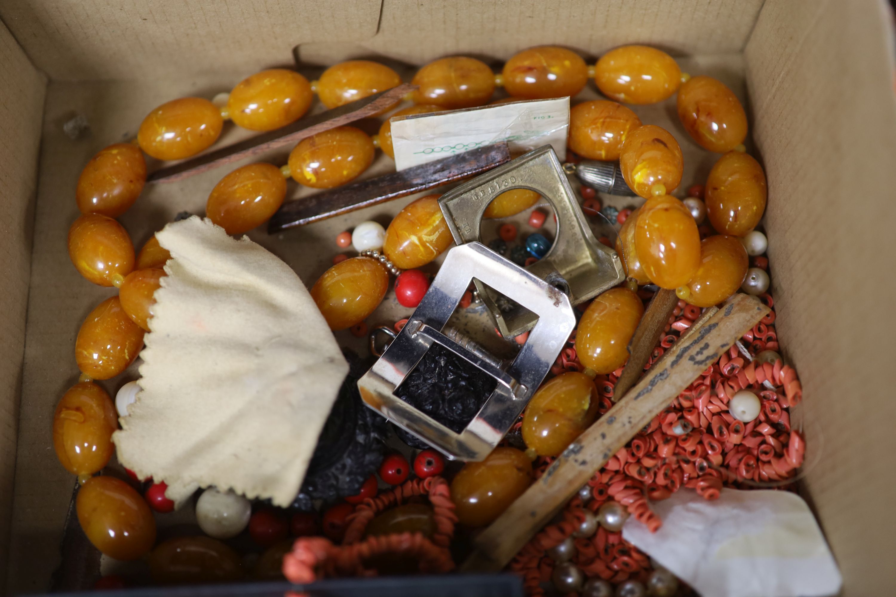 A faux amber necklace and a quantity of other assorted loose beads etc. including coral.